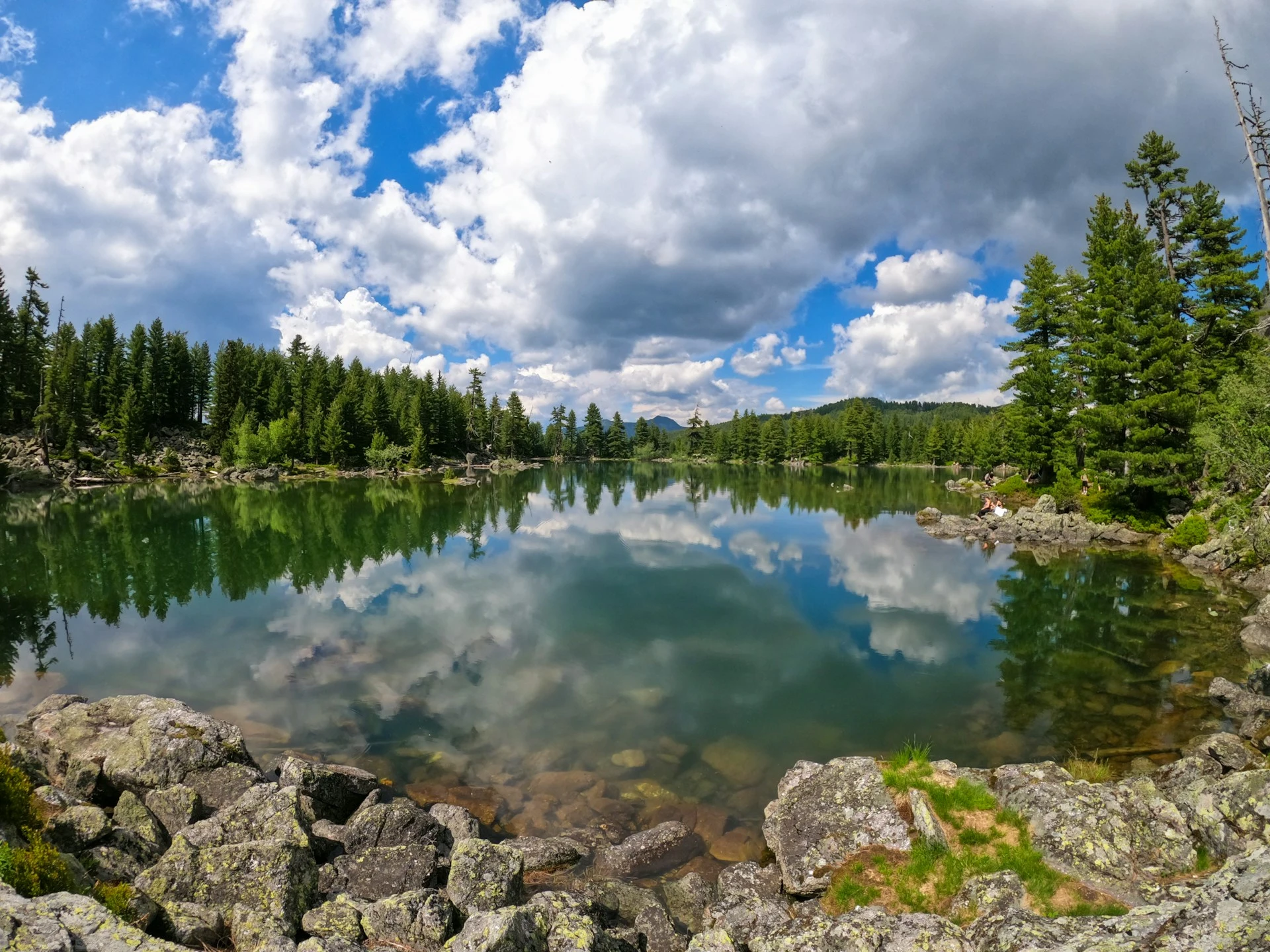 Lake Hrid surrounded by forest and peaks in the Prokletije Mountains